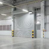 Roller shutter door and concrete floor outside factory building for industry background.