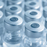 Vials of medicine or vaccine. Blue tint. Very narrow depth of field.