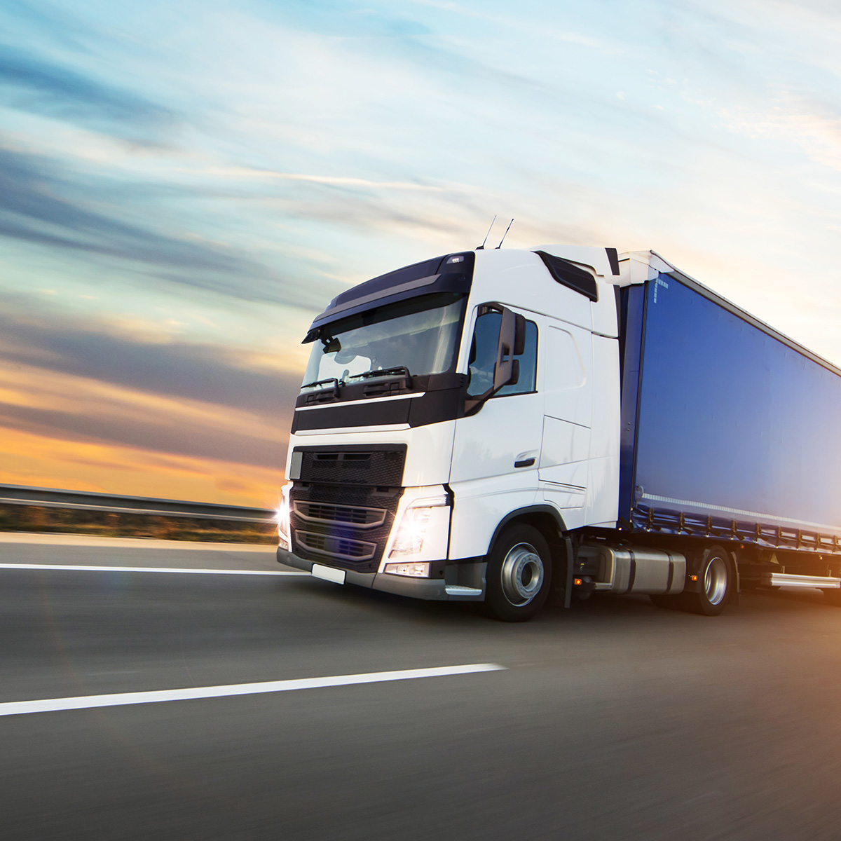 Loaded European truck on motorway in sunset