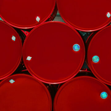 red steel chemical tanks or oil tanks stacked in a row. background and texture